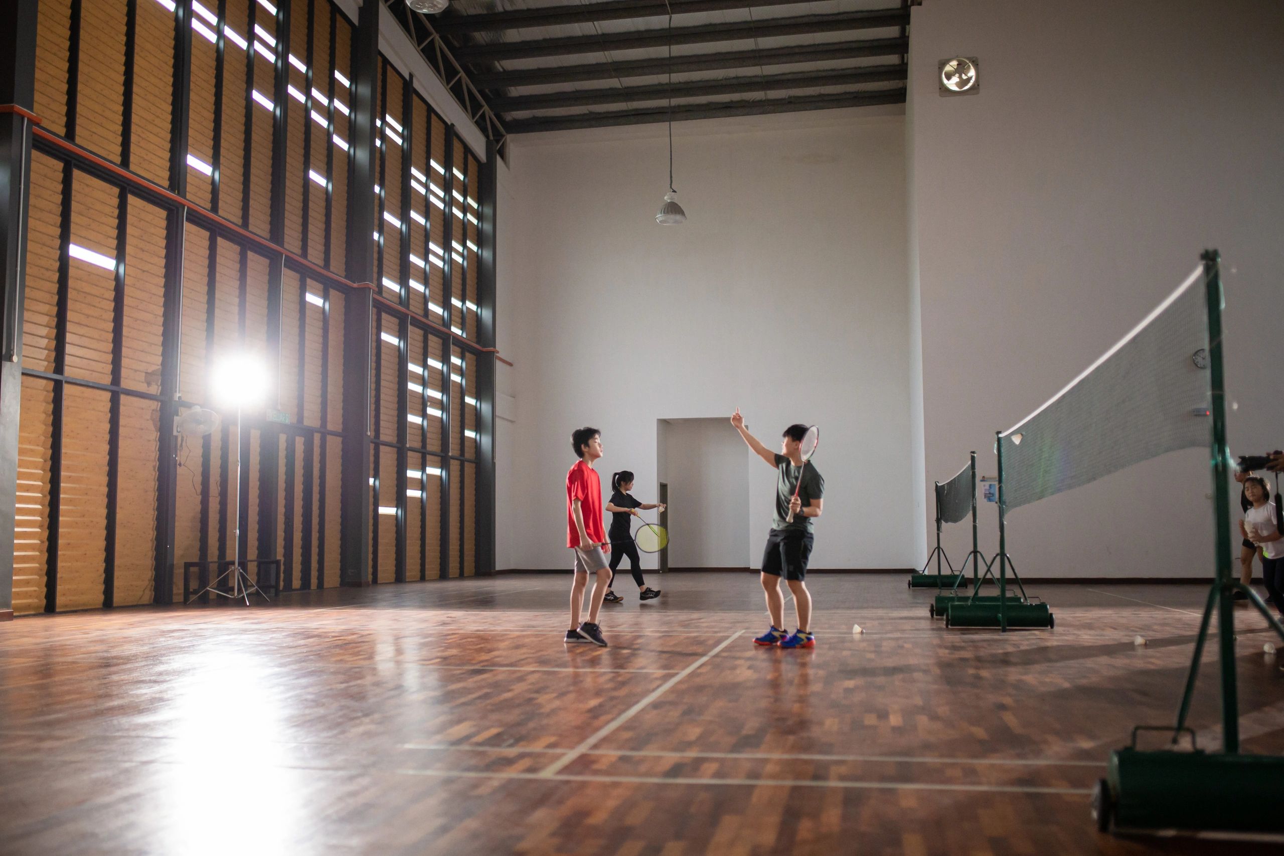 Badminton coaching session in an indoor court