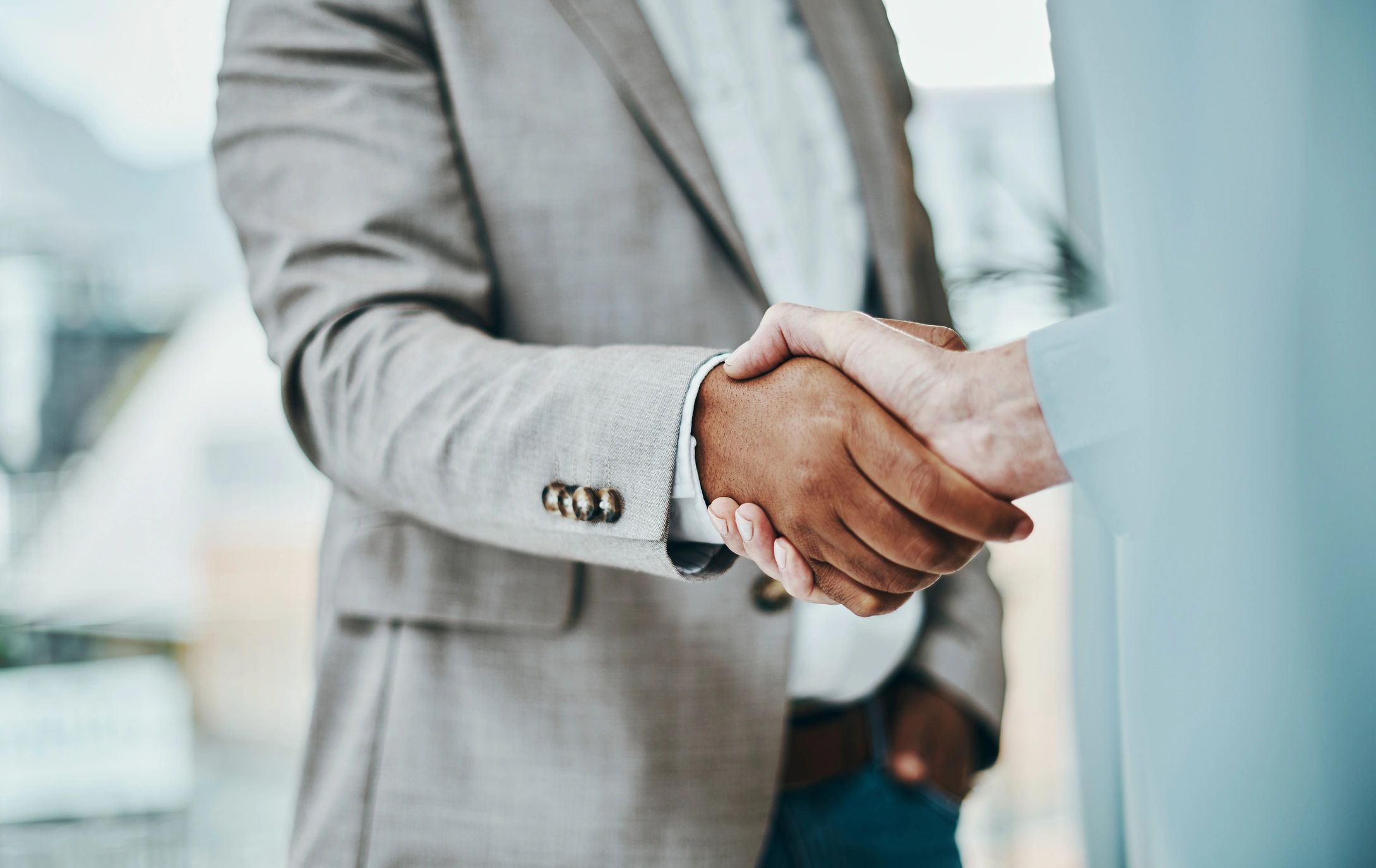Handshake in a modern office representing recruitment partnership