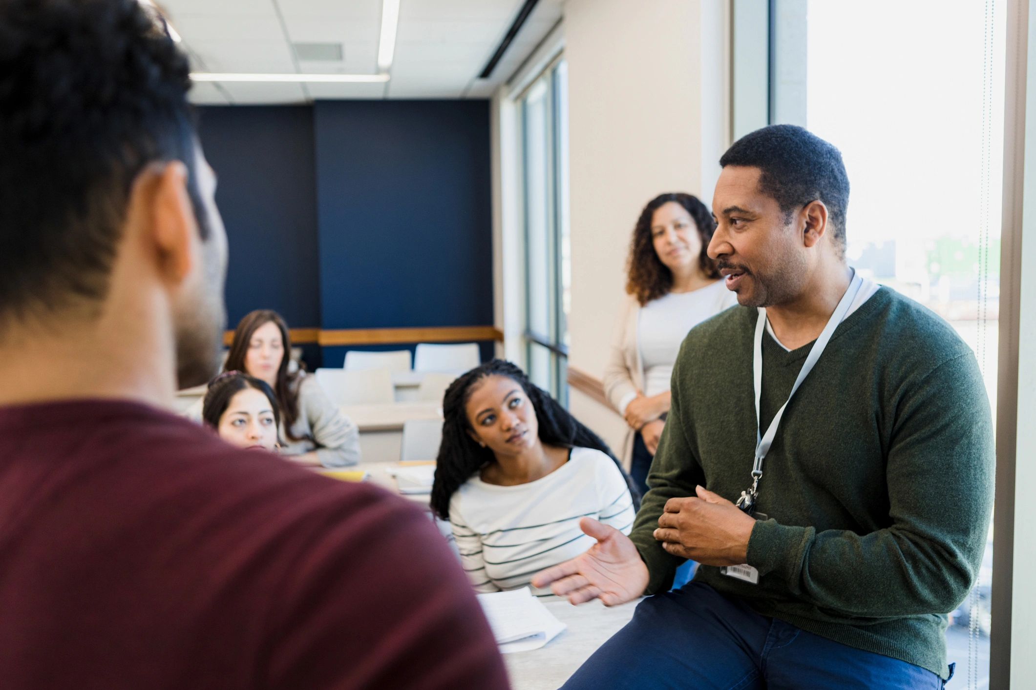 Tutor addressing students in a classroom