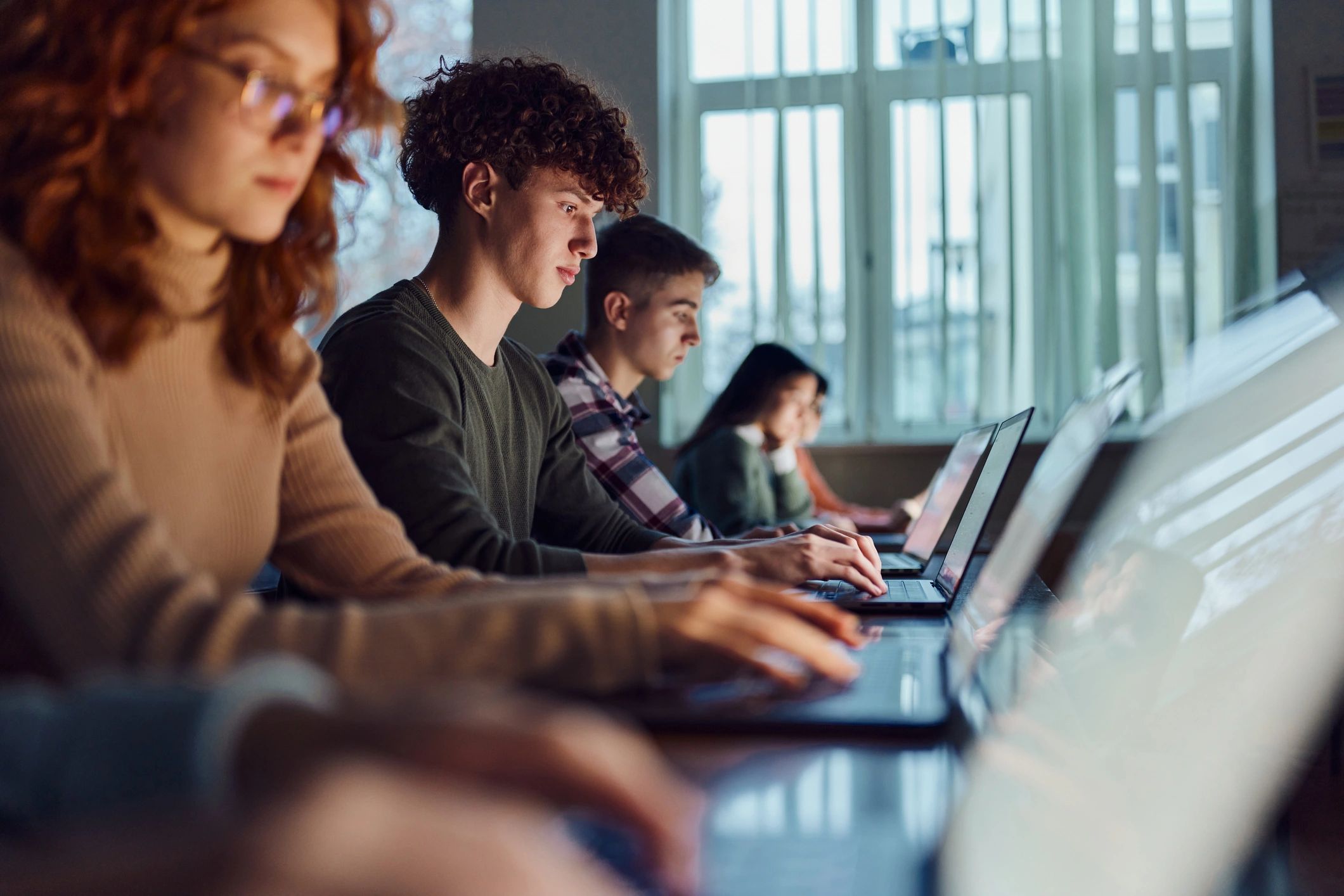 Students learning with computers in a classroom