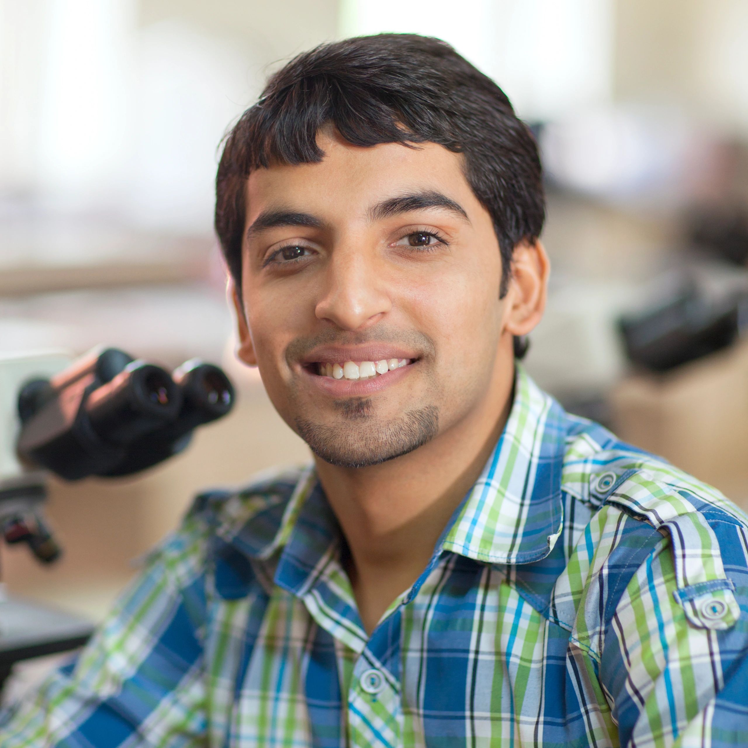 Student in a laboratory with microscope