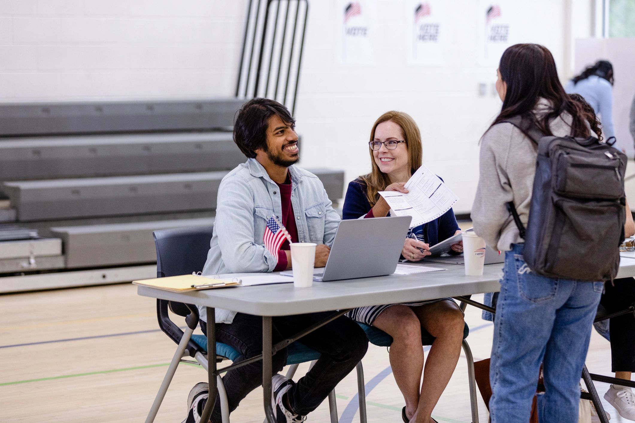 Student speaking with a volunteer at an event