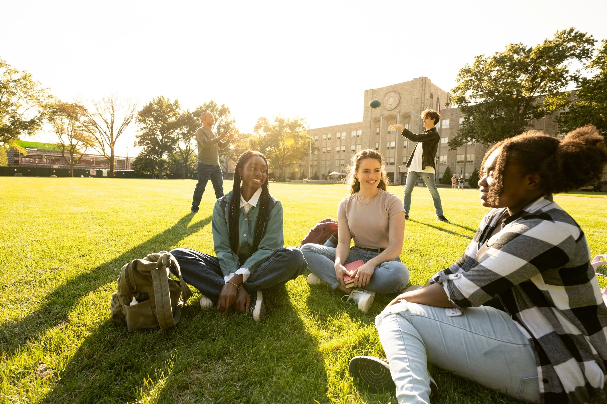 Students playing football on campus