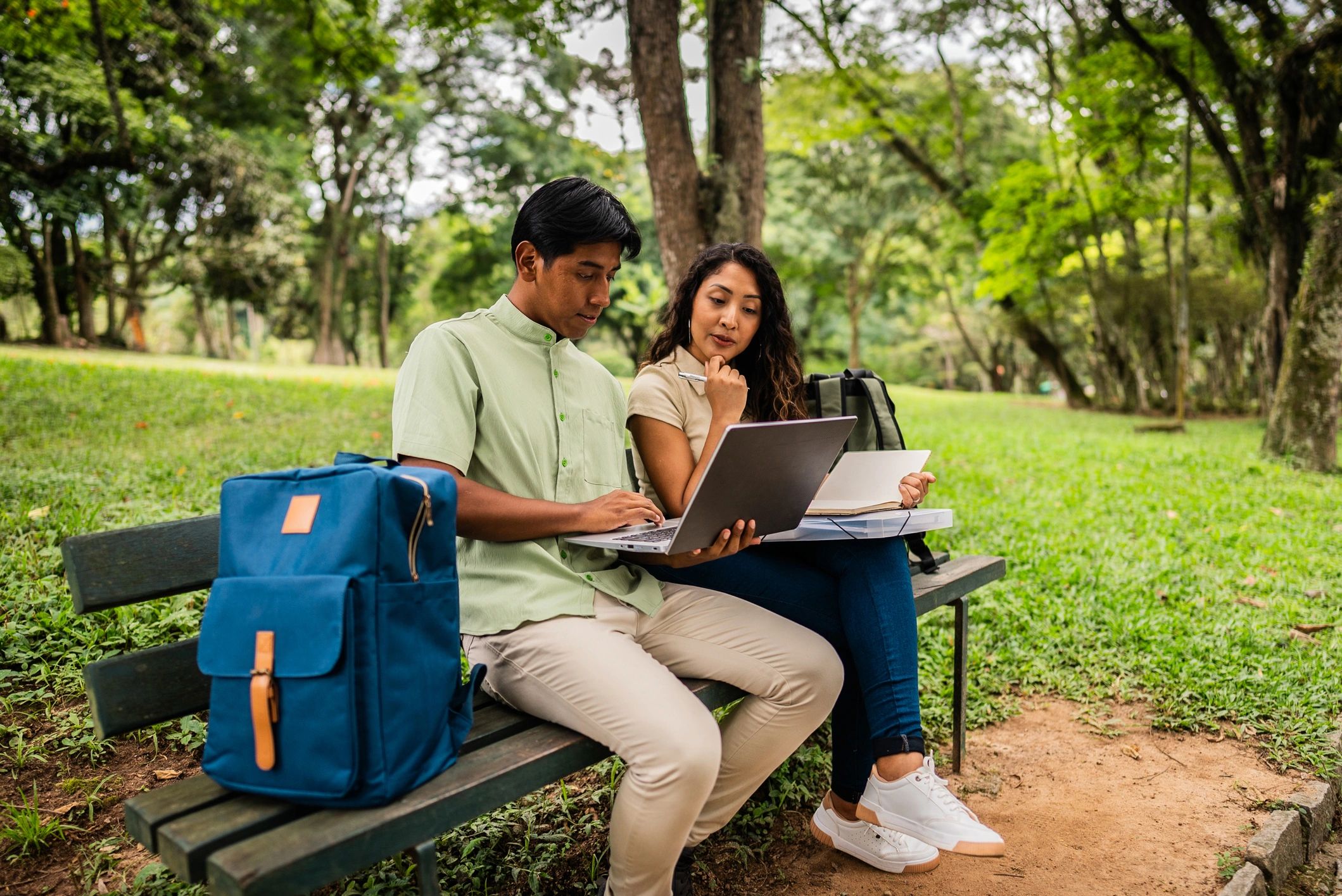 Students reviewing documents and a laptop for an application