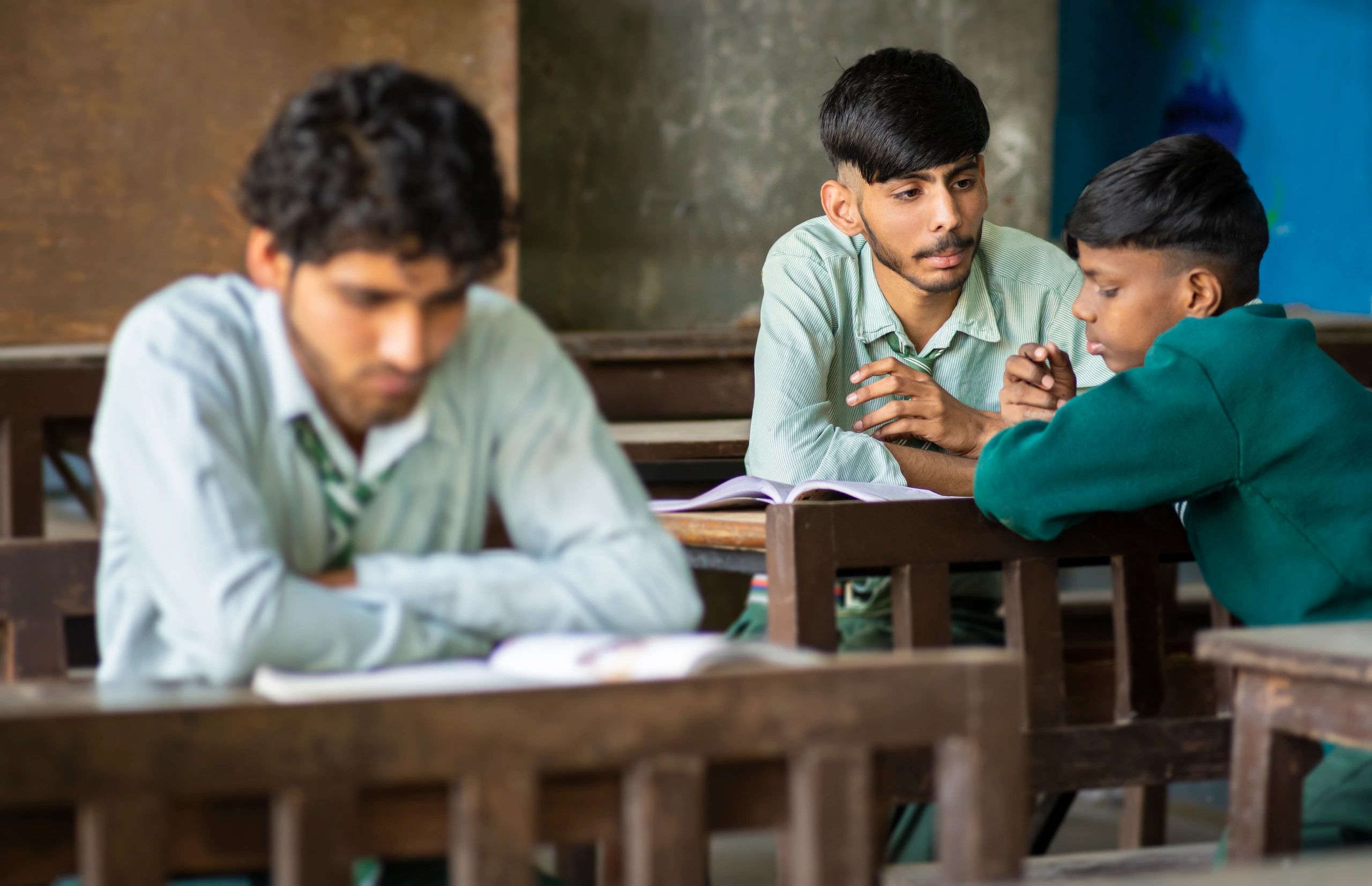Students discussing coursework in a classroom