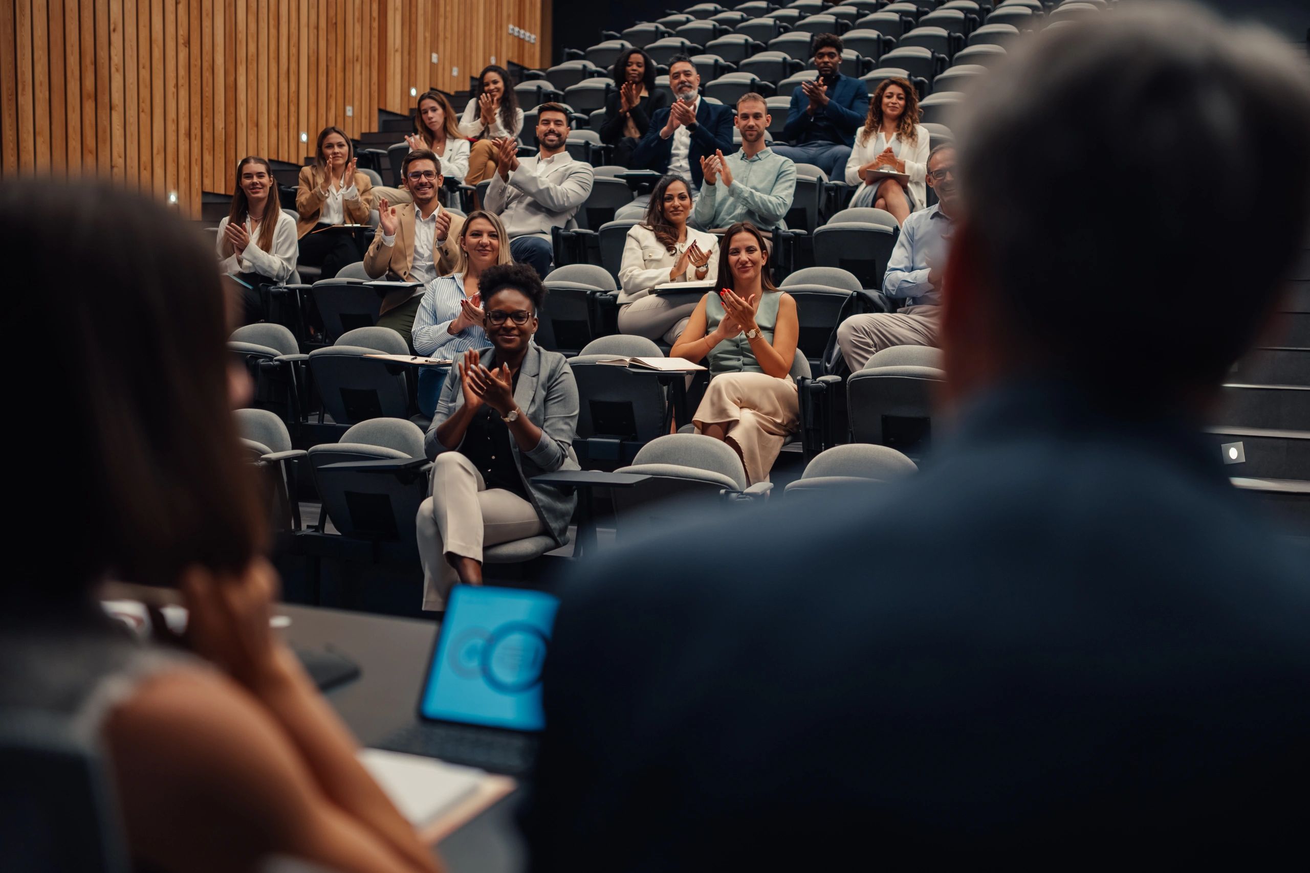 Audience applauding during a seminar