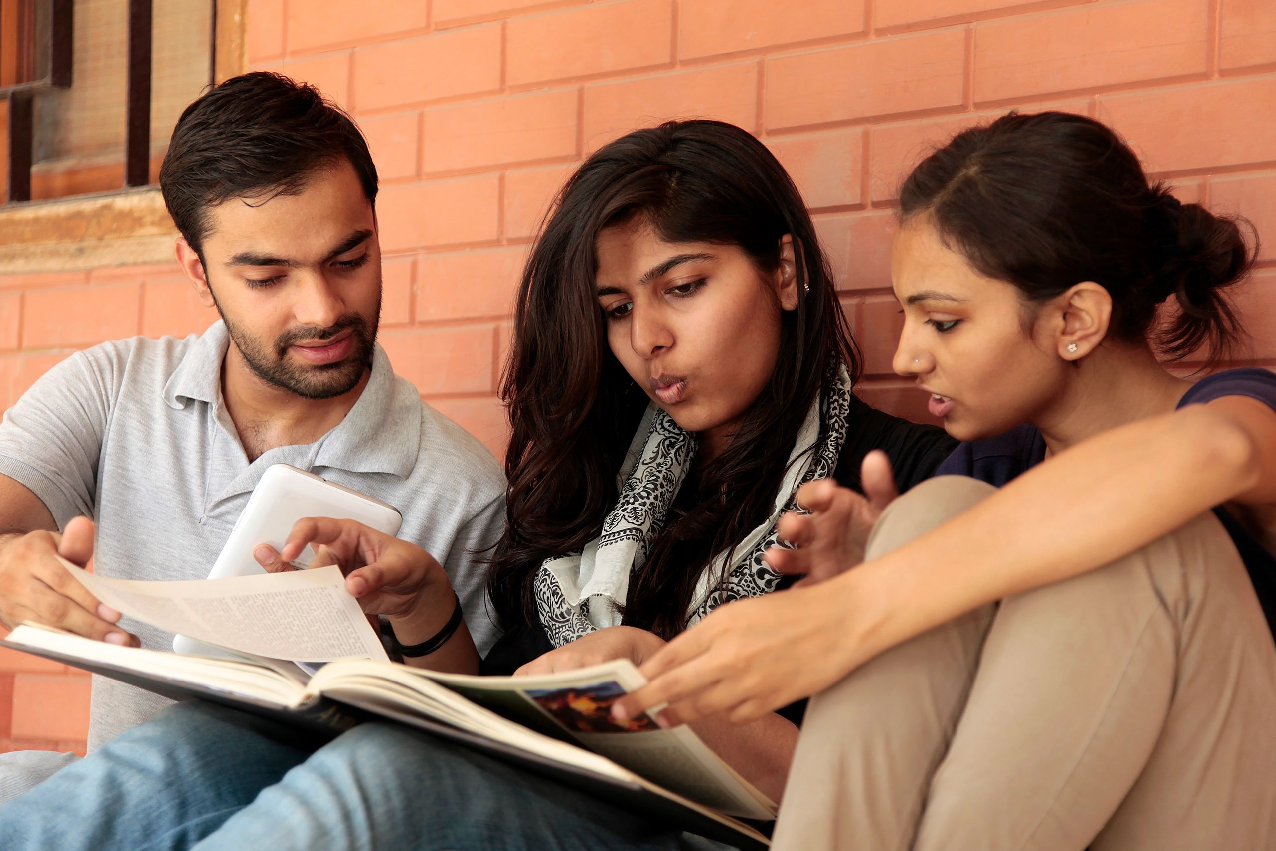 Students reading on a college campus