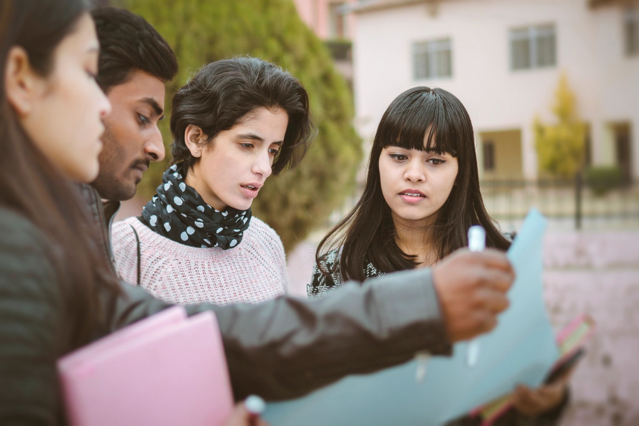 Students discussing near campus notice board