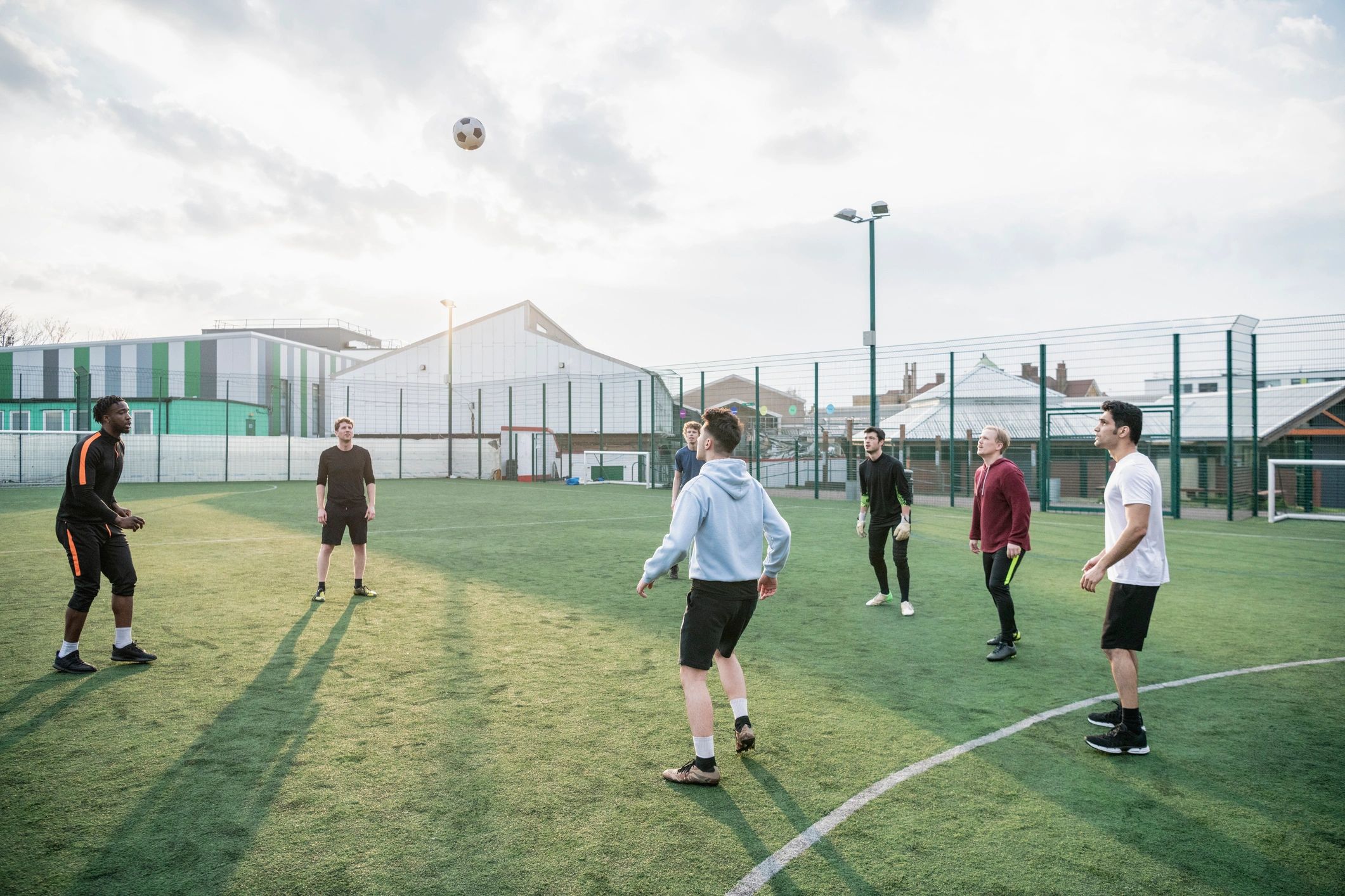 Students practising football skills in a group